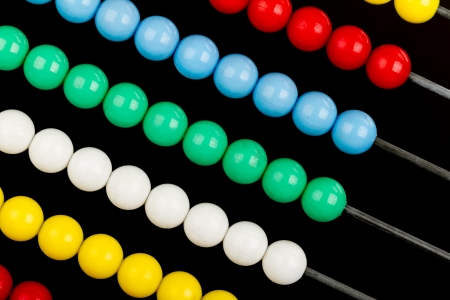 Close-up of an abacus on a black backgroundの写真素材