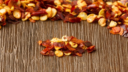 Heap of chili on isolated wood background