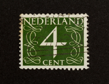 THE NETHERLANDS - CIRCA 1950: Stamp printed in the Netherlands shows the number 4, circa 1950の写真素材