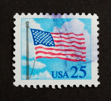 USA - CIRCA 1985: Stamp printed in the USA shows the Stars and Stripes, circa 1975の写真素材