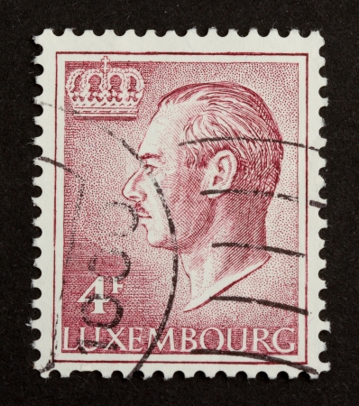 LUXEMBOURG - CIRCA 1970: Stamp printed in Luxembourg shows a kings crown, circa 1970のeditorial素材