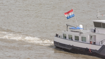 The Dutch national flag on a ship in the harbor of Rotterdamの写真素材