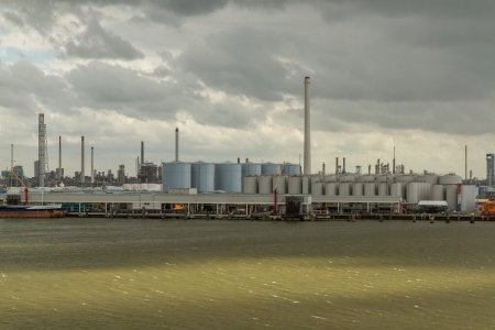 Dark clouds in the sky above the oil refineries in the dutch harbor of Rotterdamのeditorial素材