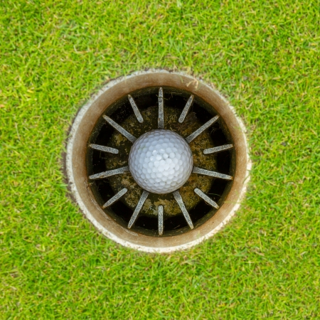 Hole in One - Golf ball in the cupの写真素材