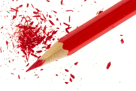 Red pencil and wood shavings isolated on whiteの写真素材