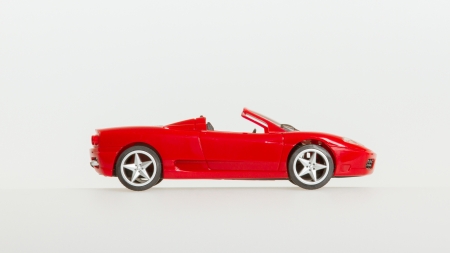 One toy car, red sportscar, isolated on white