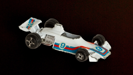 Old toy car (1970) isolated on a white background