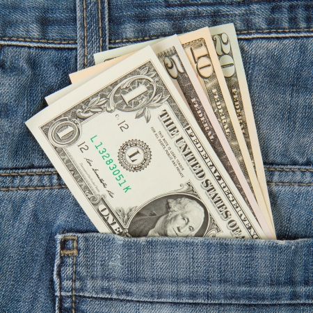 Macro shot of trendy jeans with american four different dollar bills on its pocketの写真素材