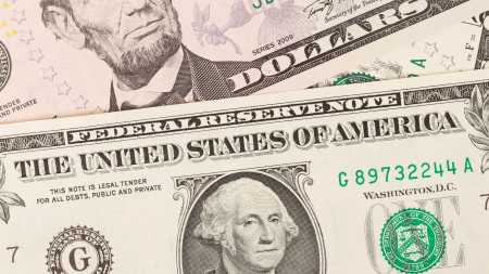 Several paper american dollars isolated in close-up (1, 5, 10, 20)