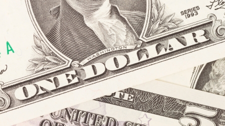 Several paper american dollars isolated in close-up (1, 5, 10, 20)