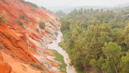 Unidentified people walking through the Ham Tien canyon in Vietnam, filled with mistの写真素材