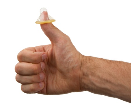 Thumbs up, condom on thumb, isolated on whiteの写真素材
