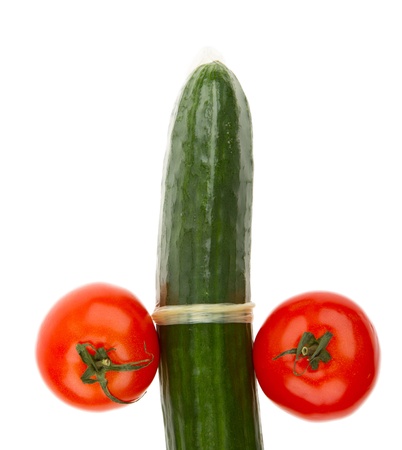 Tomatoes and cucumber in a condom isolated on whiteの写真素材