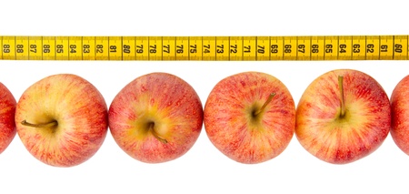 Apple diet, red apples with a yellow tape-measureの写真素材