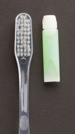 Toothbrush and green toothpaste isolated on a grey backgroundの写真素材
