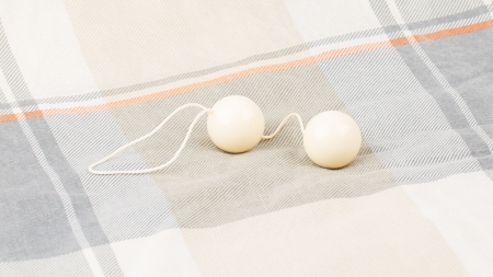 White balls isolated on an old quiltの写真素材