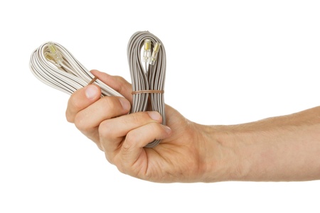 Speaker cable in a hand, isolated on a white backgroundの写真素材