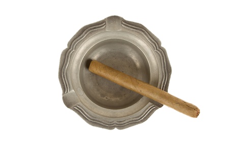 Unused large cigar in an old tin ashtray, isolated on whiteの写真素材