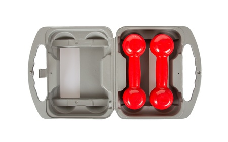 Red dumbbells in a grey case, isolated on whiteの写真素材