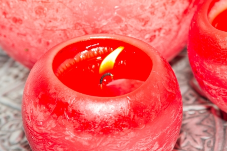 Close-up of a red candle, bright flameの写真素材