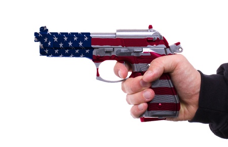 Pistol with USA flag pattern in hand, isolated on white backgroundの写真素材