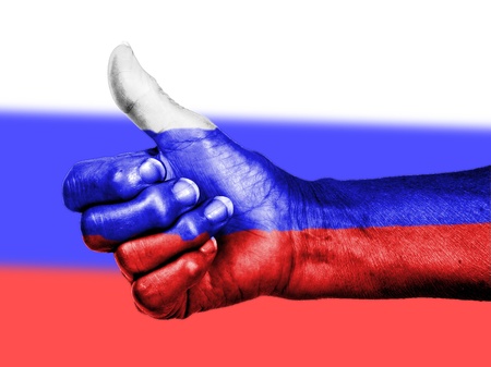 Russian flag on thumbs up hand isolated on a flag backgroundの写真素材