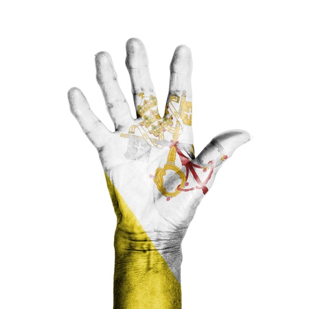 Hand of an old woman, wrapped with a pattern of the flag of the Vatican, isolated on whiteの写真素材