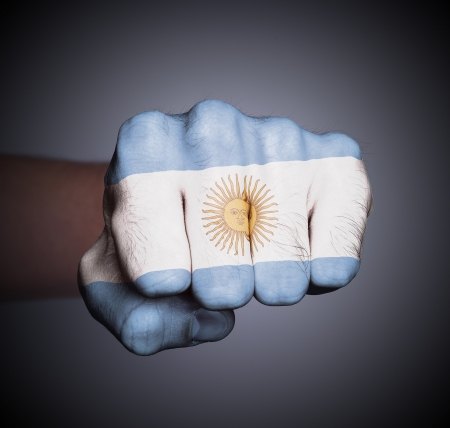 Front view of punching fist on gray background, flag of Argentinaの写真素材