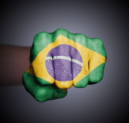 Front view of punching fist on gray background, flag of Brazilの写真素材