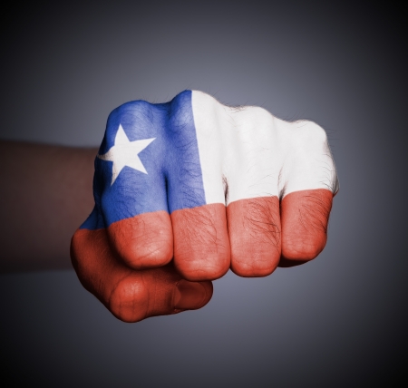 Front view of punching fist on gray background, flag of Chileの写真素材