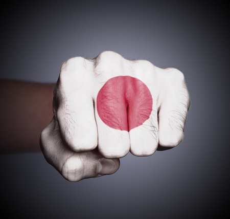 Front view of punching fist on gray background, flag of Japanの写真素材