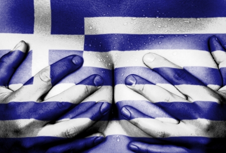 Sweaty upper part of female body, hands covering breasts, flag of Greeceの写真素材