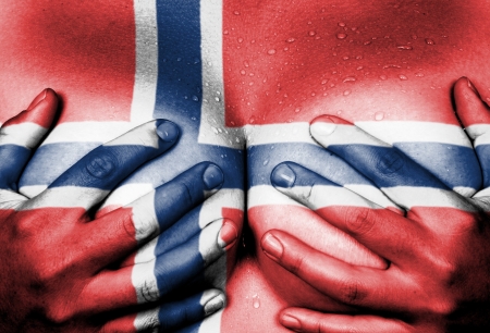 Sweaty upper part of female body, hands covering breasts, flag of Norwayの写真素材