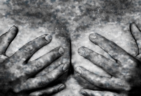Sweaty upper part of female body, hands covering breasts, camouflagedの写真素材