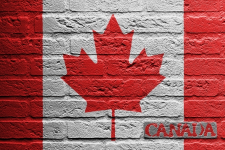 Brick wall with a painting of a flag isolated, Canadaの写真素材