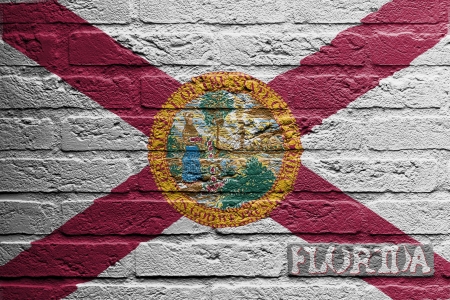 Brick wall with a painting of a flag isolated, Floridaの写真素材