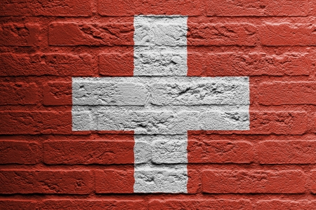 Brick wall with a painting of a flag isolated, Switzerlandの写真素材