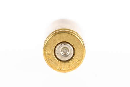 Empty shell casing against gradient, isolated on white