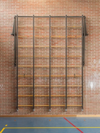 Interior of a gym at school, rack for climbing