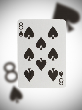 Playing card with a blurry background, eight of spadesの写真素材
