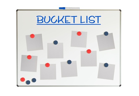 Bucket list with empty papers and magnets on a whiteboard, isolated on whiteの写真素材