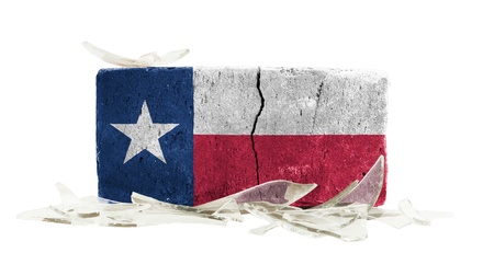 Brick with broken glass, violence concept, flag of Texas