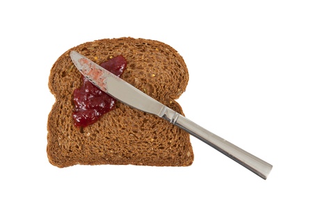 Slice of brown bread with jam isolated on whiteの写真素材