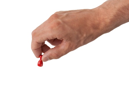 Hand holding a red pawn, isolated on whiteの写真素材