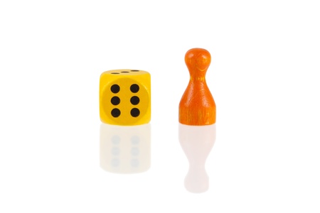 One orange pawn and a yellow dice isolated on a white backgroundの写真素材
