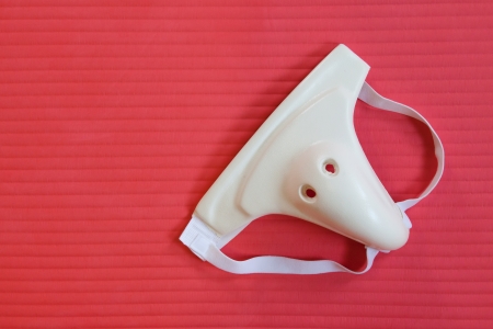 Groin protection isolated on a red matの写真素材