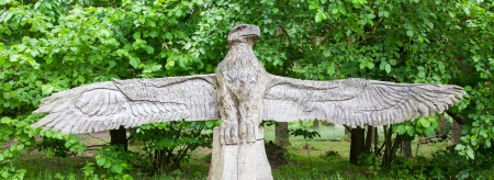 Wood craft of a eagle on top of a benchの写真素材