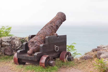 Very old rusted canon pointing at a bay, Caribbeanのeditorial素材