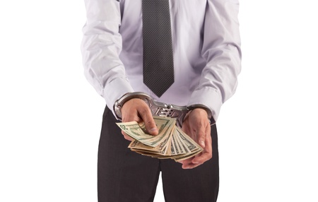 Business man in handcuffs arrested for bribe, isolated on white