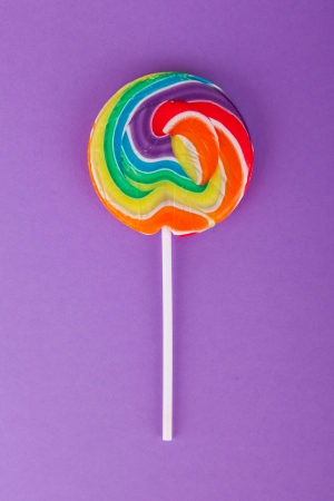 Lollypop isolated on a purple paper backgroundの写真素材